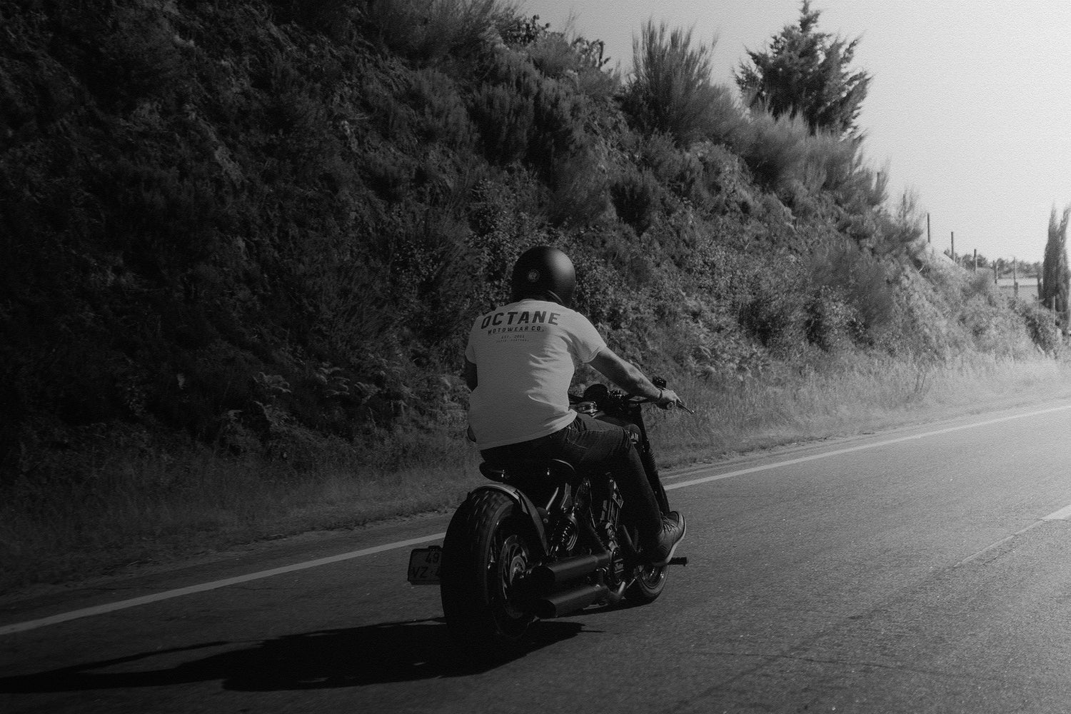 Motorcycle rider in Indian Scout Bobber wearing Octane Motowear Address Tee t-shirt.